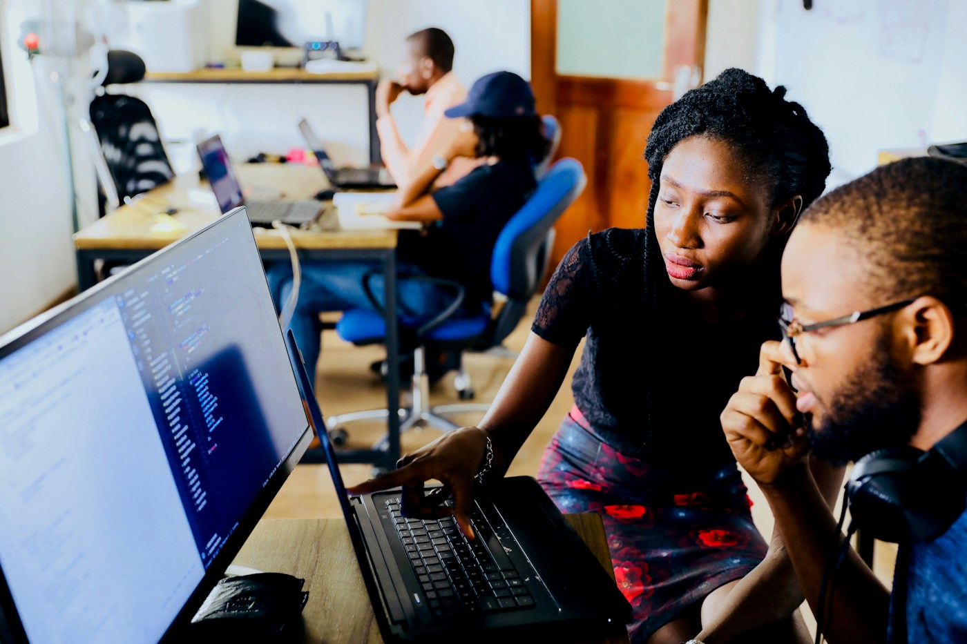 Two professionals collaborating at a computer