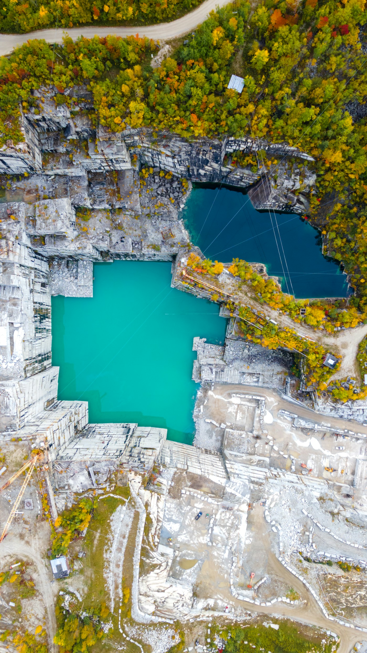 Aerial view of a granite quarry and turquoise water